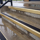 Square edge aluminium stair nosing with black gritted exterior grip insert in satin gold finish fitted on covered external concrete steps