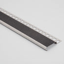 55mm brushed stainless steel stair nosing profile with black mineral grain anti-slip tread on a plain studio background