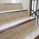 Stainless steel tile-in stair nosing with NB Nut Brown RAL 8007 ribbed insert on cream tiled stairs