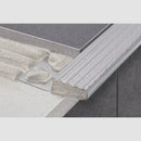 Cutaway of the stainless steel tile-in stair nosing with its perforated anchoring leg bedded in tile adhesive beneath the stair tile