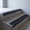 Black anodised 46x30mm stair nosing with black anti-slip rubber insert fitted to bare concrete stairs