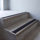 Champagne anodised 46x30mm stair nosing with black anti-slip rubber insert fitted to bare concrete stairs