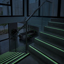 56x32mm stair nosing glowing green along each step edge in a dark stairwell during a power cut, no wiring or power needed