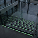 57x32mm stair nosing glowing green along each step edge in a dark stairwell during a power cut, no wiring or power needed