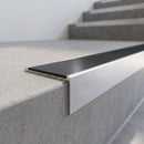 Slimline 59x30mm square back aluminium stair nosing with a black anodised aluminium insert, on a satin aluminium bar, fitted along the front edge of a concrete step
