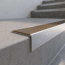 Slimline 59x30mm square back aluminium stair nosing with a bronze anodised aluminium insert, on a satin aluminium bar, fitted along the front edge of a concrete step