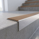 Slimline 59x30mm square back aluminium stair nosing with a fawn sandy-brown ribbed PVC insert, on a satin aluminium bar, fitted along the front edge of a concrete step