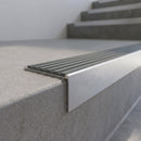 Slimline 59x30mm square back aluminium stair nosing with a flint grey ribbed PVC insert, on a satin aluminium bar, fitted along the front edge of a concrete step