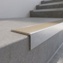 Slimline 59x30mm square back aluminium stair nosing with a light bronze anodised aluminium insert, on a satin aluminium bar, fitted along the front edge of a concrete step