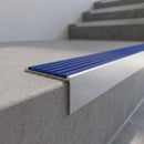 Slimline 59x30mm square back aluminium stair nosing with a mid blue ribbed PVC insert, on a satin aluminium bar, fitted along the front edge of a concrete step
