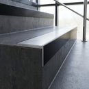 Slimline 59x30mm square back aluminium stair nosing with a mill finish aluminium insert, on a black anodised bar, fitted along the front edge of a concrete step