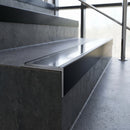 Slimline 59x30mm square back aluminium stair nosing with a polished anodised aluminium insert, on a black anodised bar, fitted along the front edge of a concrete step