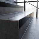Slimline 59x30mm square back aluminium stair nosing with a satin anodised aluminium insert, on a black anodised bar, fitted along the front edge of a concrete step