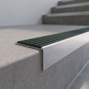 Slimline 59x30mm square back aluminium stair nosing with a spruce forest-green ribbed PVC insert, on a satin aluminium bar, fitted along the front edge of a concrete step