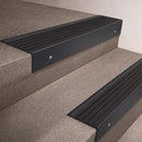 Black Anodised finish 66x55mm raked back aluminium stair nosing with a Black Castellated insert, fitted to interior steps