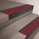 Black Anodised finish 66x55mm raked back aluminium stair nosing with a Claret Castellated insert, fitted to interior steps