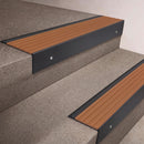 Black Anodised finish 66x55mm raked back aluminium stair nosing with a Fawn Castellated insert, fitted to interior steps
