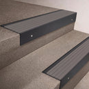 Black Anodised finish 66x55mm raked back aluminium stair nosing with a Flint Castellated insert, fitted to interior steps