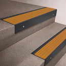 Black Anodised finish 66x55mm raked back aluminium stair nosing with a Gold Castellated insert, fitted to interior steps