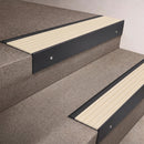 Black Anodised finish 66x55mm raked back aluminium stair nosing with a Ivory Castellated insert, fitted to interior steps