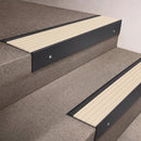 Black Anodised finish 66x55mm raked back aluminium stair nosing with a Ivory Castellated insert, fitted to interior steps