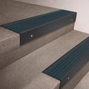 Black Anodised finish 66x55mm raked back aluminium stair nosing with a Jade Castellated insert, fitted to interior steps
