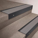 Black Anodised finish 66x55mm raked back aluminium stair nosing with a Light Grey Castellated insert, fitted to interior steps