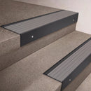 Black Anodised finish 66x55mm raked back aluminium stair nosing with a Light Grey Castellated insert, fitted to interior steps