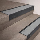 Black Anodised finish 66x55mm raked back aluminium stair nosing with a Light Grey Smooth Textured insert, fitted to interior steps