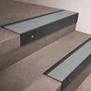 Black Anodised finish 66x55mm raked back aluminium stair nosing with a Light Grey Smooth Textured insert, fitted to interior steps