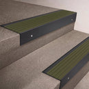 Black Anodised finish 66x55mm raked back aluminium stair nosing with a Olive Castellated insert, fitted to interior steps