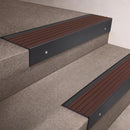 Black Anodised finish 66x55mm raked back aluminium stair nosing with a Peat Castellated insert, fitted to interior steps