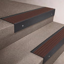 Black Anodised finish 66x55mm raked back aluminium stair nosing with a Peat Castellated insert, fitted to interior steps