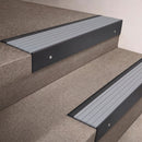 Black Anodised finish 66x55mm raked back aluminium stair nosing with a Polar Grey Castellated insert, fitted to interior steps