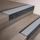 Black Anodised finish 66x55mm raked back aluminium stair nosing with a Polar Grey Smooth Textured insert, fitted to interior steps