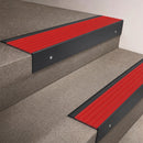Black Anodised finish on a 66x55mm raked back aluminium stair nosing with a Poppy red insert, fitted indoors