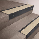 Black Anodised finish 66x55mm raked back aluminium stair nosing with a Porth Stone Smooth Textured insert, fitted to interior steps