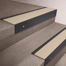 Black Anodised finish 66x55mm raked back aluminium stair nosing with a Porth Stone Smooth Textured insert, fitted to interior steps