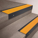 Black Anodised finish 66x55mm raked back aluminium stair nosing with a Yellow Castellated insert, fitted to interior steps