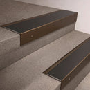 Bronze finish 66x55mm raked back aluminium stair nosing with a Black Anodised Aluminium insert, fitted to interior steps
