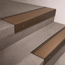 Bronze finish 66x55mm raked back aluminium stair nosing with a Bronze Aluminium insert, fitted to interior steps