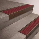 Bronze finish 66x55mm raked back aluminium stair nosing with a Claret Castellated insert, fitted to interior steps