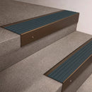 Bronze finish 66x55mm raked back aluminium stair nosing with a Jade Castellated insert, fitted to interior steps