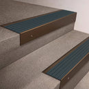 Bronze finish 66x55mm raked back aluminium stair nosing with a Jade Castellated insert, fitted to interior steps