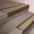 Bronze finish 66x55mm raked back aluminium stair nosing with a Light Bronze Aluminium insert, fitted to interior steps
