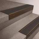 Bronze finish 66x55mm raked back aluminium stair nosing with a Nimbus Castellated insert, fitted to interior steps