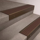 Bronze finish 66x55mm raked back aluminium stair nosing with a Peat Castellated insert, fitted to interior steps