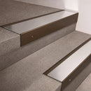 Bronze finish 66x55mm raked back aluminium stair nosing with a Polished Aluminium insert, fitted to interior steps