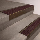 Bronze finish 66x55mm raked back aluminium stair nosing with a Regency Castellated insert, fitted to interior steps