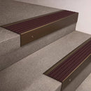 Bronze finish 66x55mm raked back aluminium stair nosing with a Regency Castellated insert, fitted to interior steps